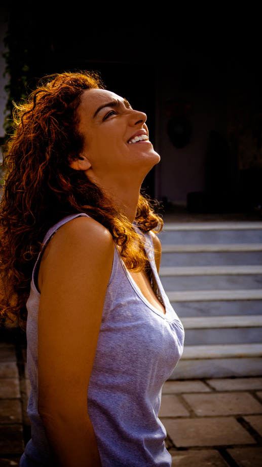 Smiling Woman Wearing Sleeveless Top